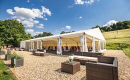 Elegant clearspan marquee set on a countryside gravel terrace with outdoor seating in Surrey