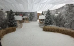 Winter wonderland themed marquee interior with snow effects and festive decorations in London