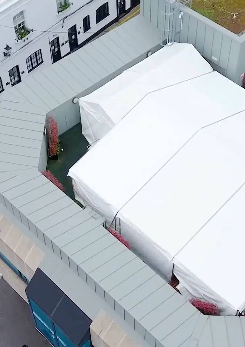 Aerial view of rooftop marquee structure installed within restricted urban terrace space
